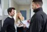 Bailiff Talking With Sad Couple At Home Entrance
